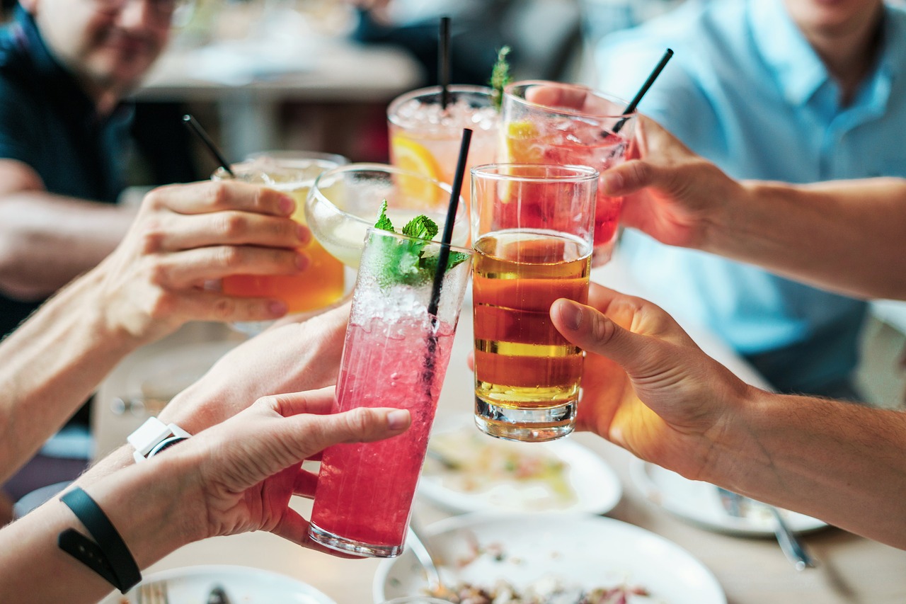 Group of friends cheering their drinks together.